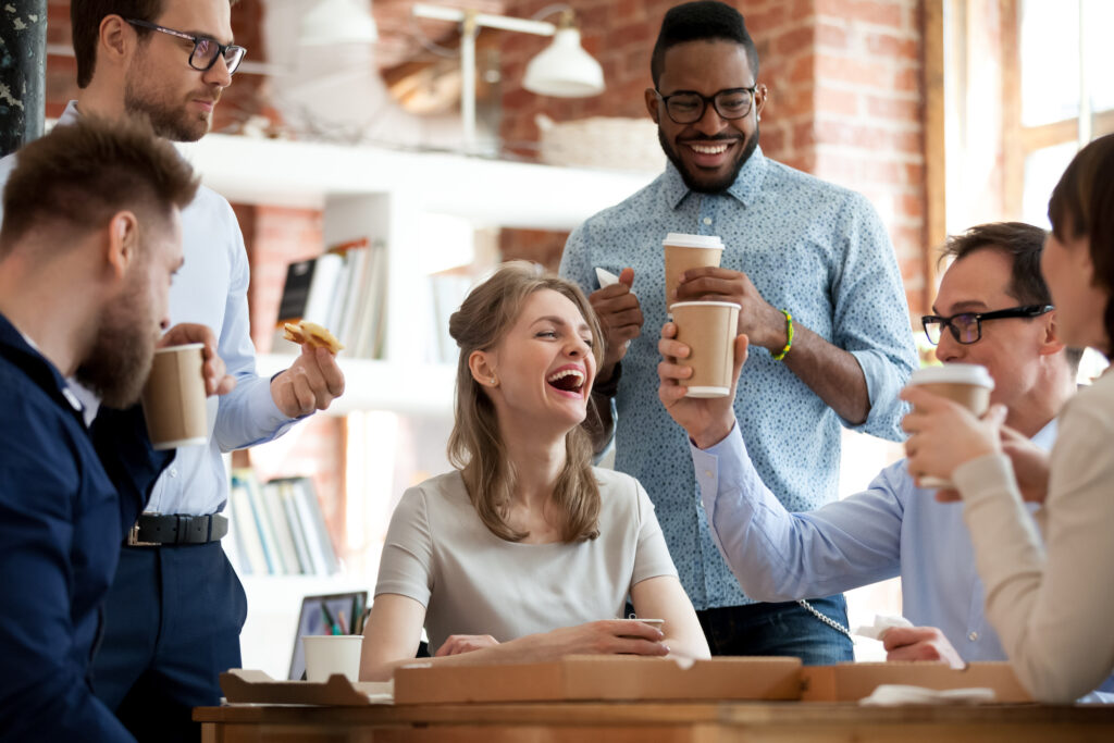 Happy colleagues celebrate during lunch break in office
